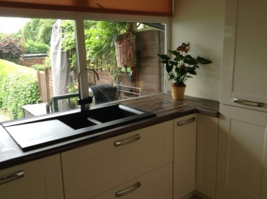 The utility area with deep sink drawers, built in boiler housing / ironing board cupboard and integrated washing machine.